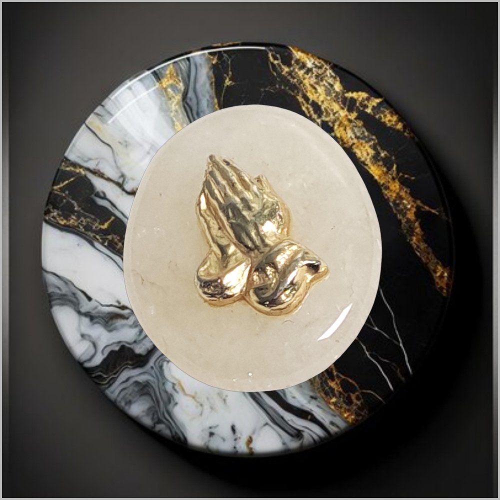Praying Gold Hands on a Cream Color Natural Stone